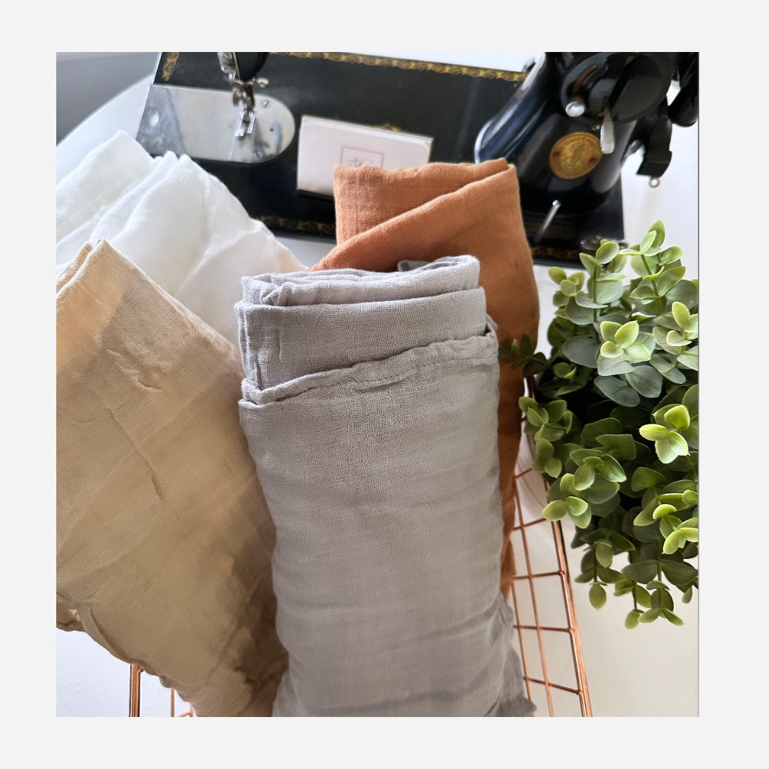 White muslin swaddle blanket